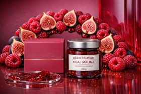 Słoik dżemu figowego z malinami obok czerwonego pudełka i świeżych owoców